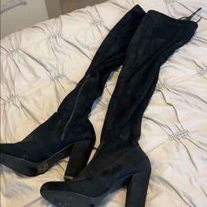 Thigh high black heeled boots